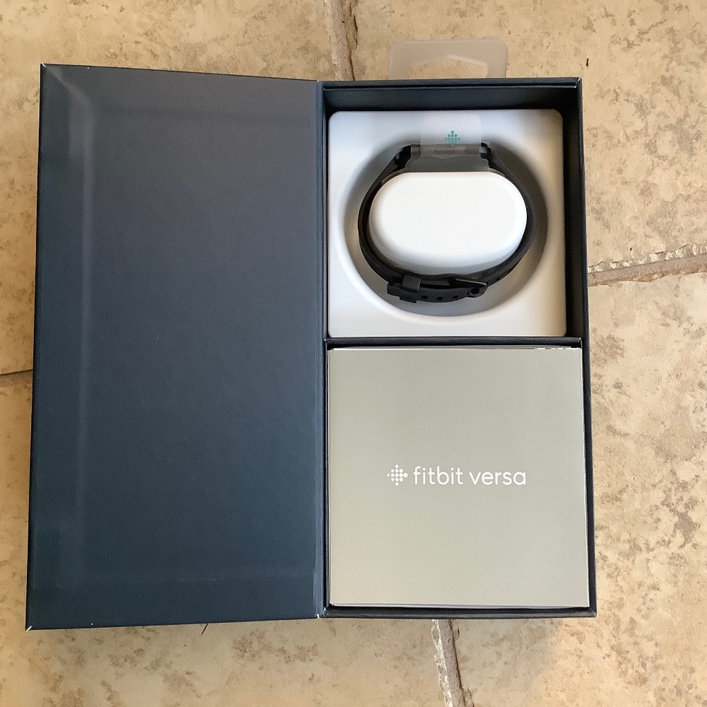 Fitbit versa smart watch and fitness  tracker in black.